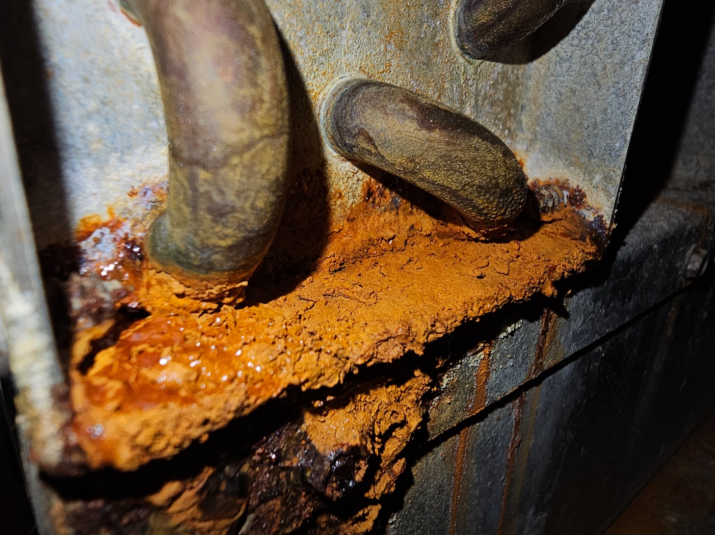 Corrosion inside a heat pump drain pan, from the HTS condo HVAC service photo collection
