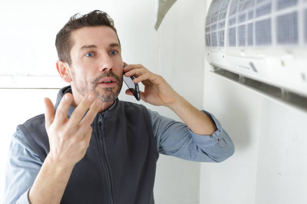 A man speaking with an HVAC technician because his Condo HVAC is not working